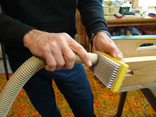 Vacuum the bristles of your wax brush