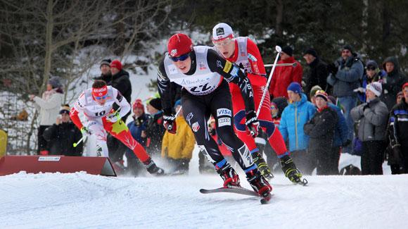  	 Noah Hoffman charges hard around a corner, leading the pack en route a career best eighth in the 30k skiathlon at the Canmore World Cup. (Robert Whitney)