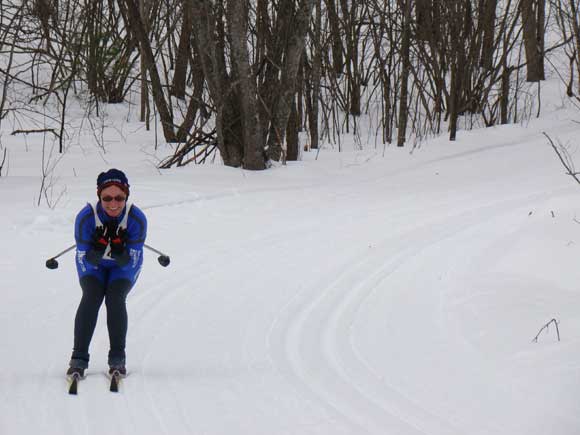 Team NordicSkiRacer Linda Allen tucks the last downhill at the Hanson Hills Classic xc ski race.