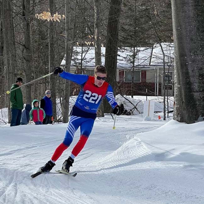Cross country skier rounding a fast downhill corner