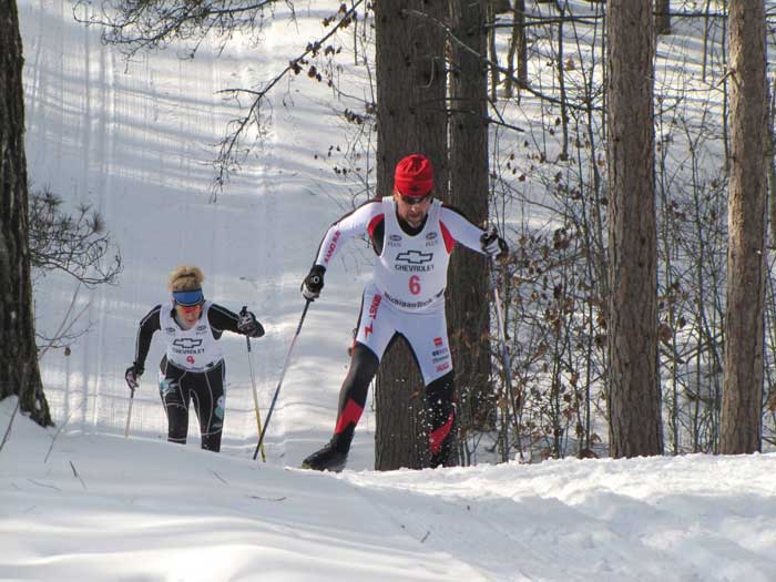 Blair Zordell herringbones up the hill with Tracy Hardin in pursuit.