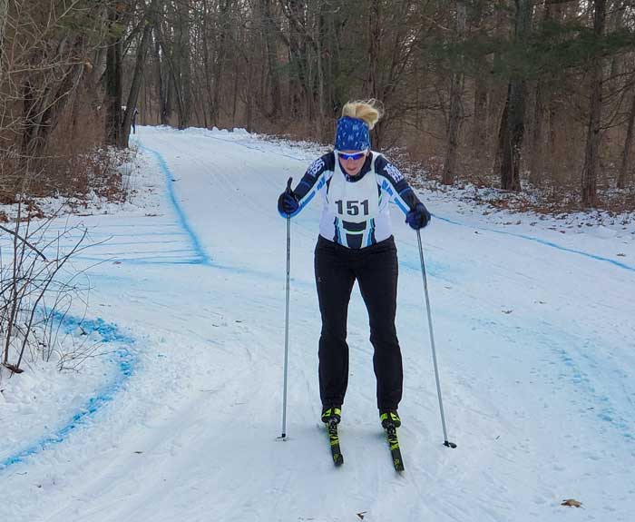 Krazy Klassic cross country ski racers on the course - Jenna Briggs rounds the final corner
