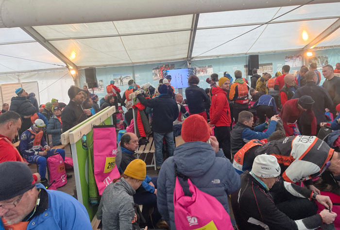 Warm up tent, showing Women elite skiers on screen