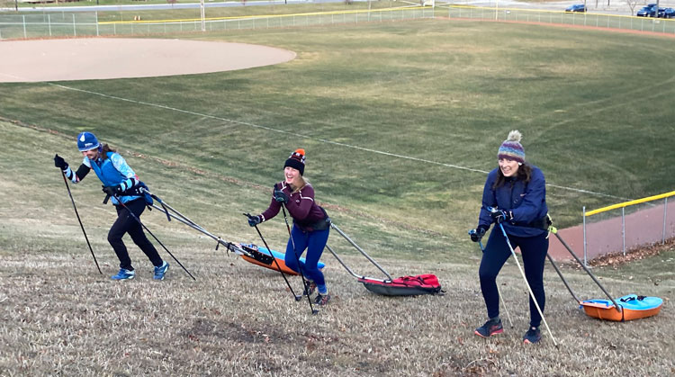Team NordicSkiRacer women doing dry land hill training with weighted sleds. Go Sarah Newmister, Kirsten Hensley, and Skye Schultz...and Cathy Susan who took the photo!