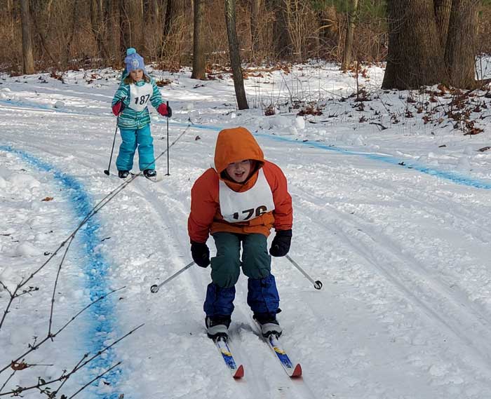 Krazy Klassic  cross country ski racers on the course - Rayne Newmister leads Avery Ludlow in the 5km