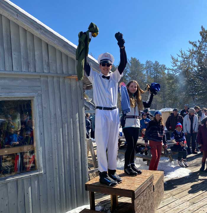 Milk-man constumed cross country ski racer
